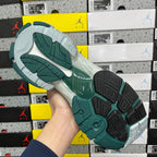 Runner sneaker outsole with textured traction, teal rubber sections and gray base.