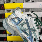 Runner sneaker top view with white mesh, teal stripe detailing, green laces, thick sole.