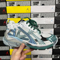 Runner sneaker with white mesh, teal stripes, green laces, and chunky rubber sole.