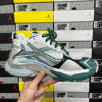 Runner sneaker front side with white mesh, teal stripes, green laces, chunky sole.