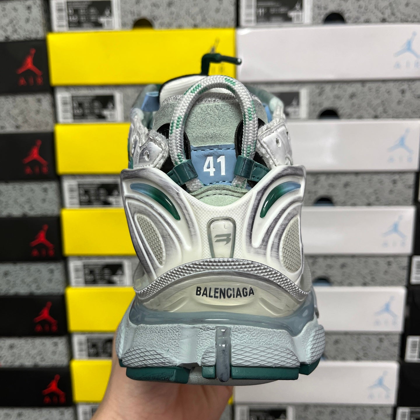 Runner sneaker back view with size 41 patch and Balenciaga logo, teal accents.