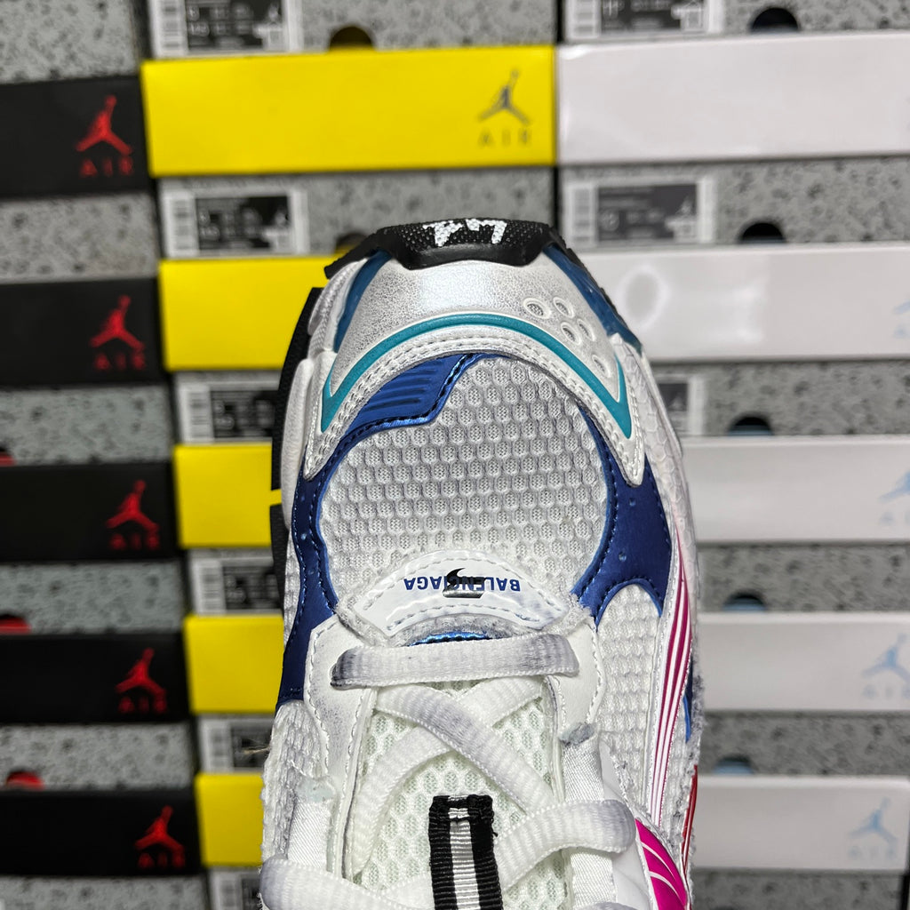 White sneaker heel with blue panel, lace detail, and black pull tab