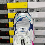 White sneaker heel with blue panel, lace detail, and black pull tab