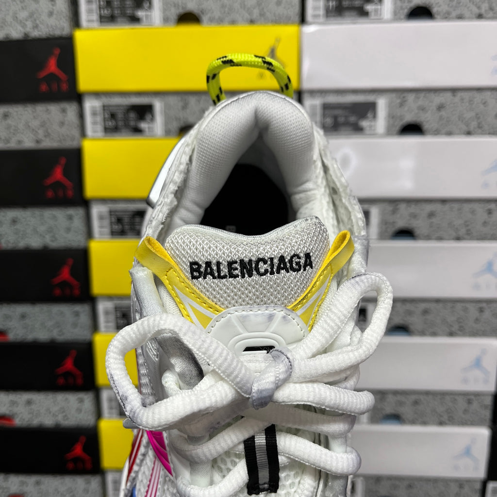 White Balenciaga sneaker heel with yellow pull loop and black logo lettering