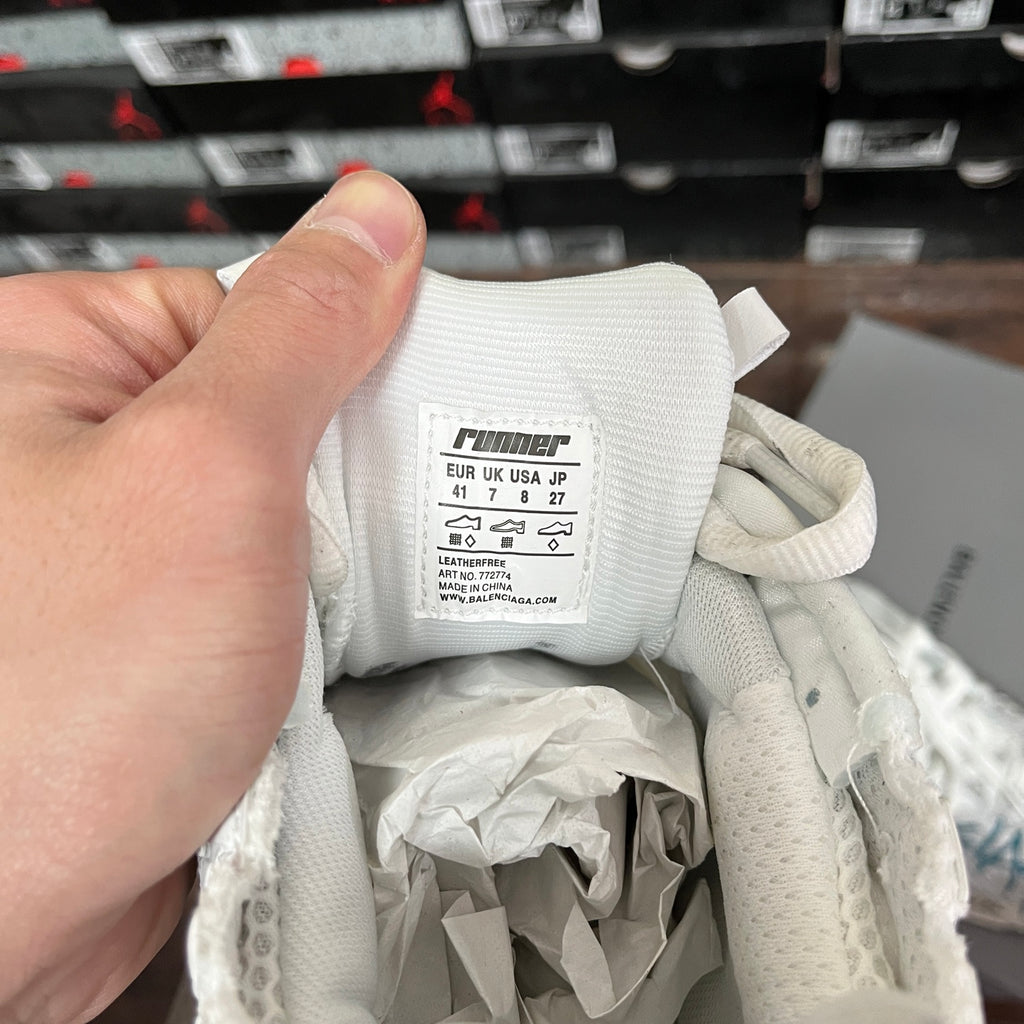 White sneaker interior size tag with EU/UK/US sizing and care details.