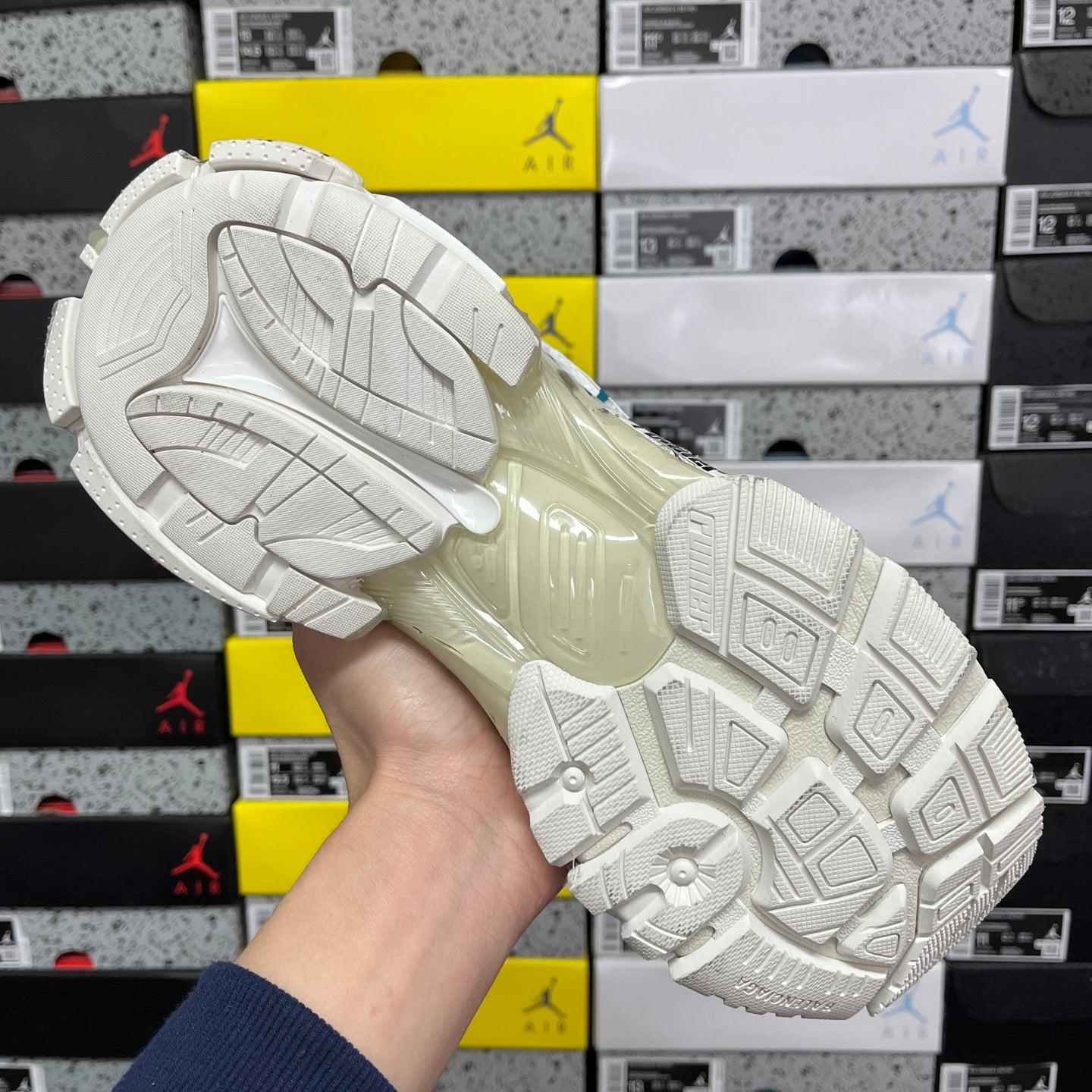 White sneaker outsole with patterned traction tread and thick rubber platform.