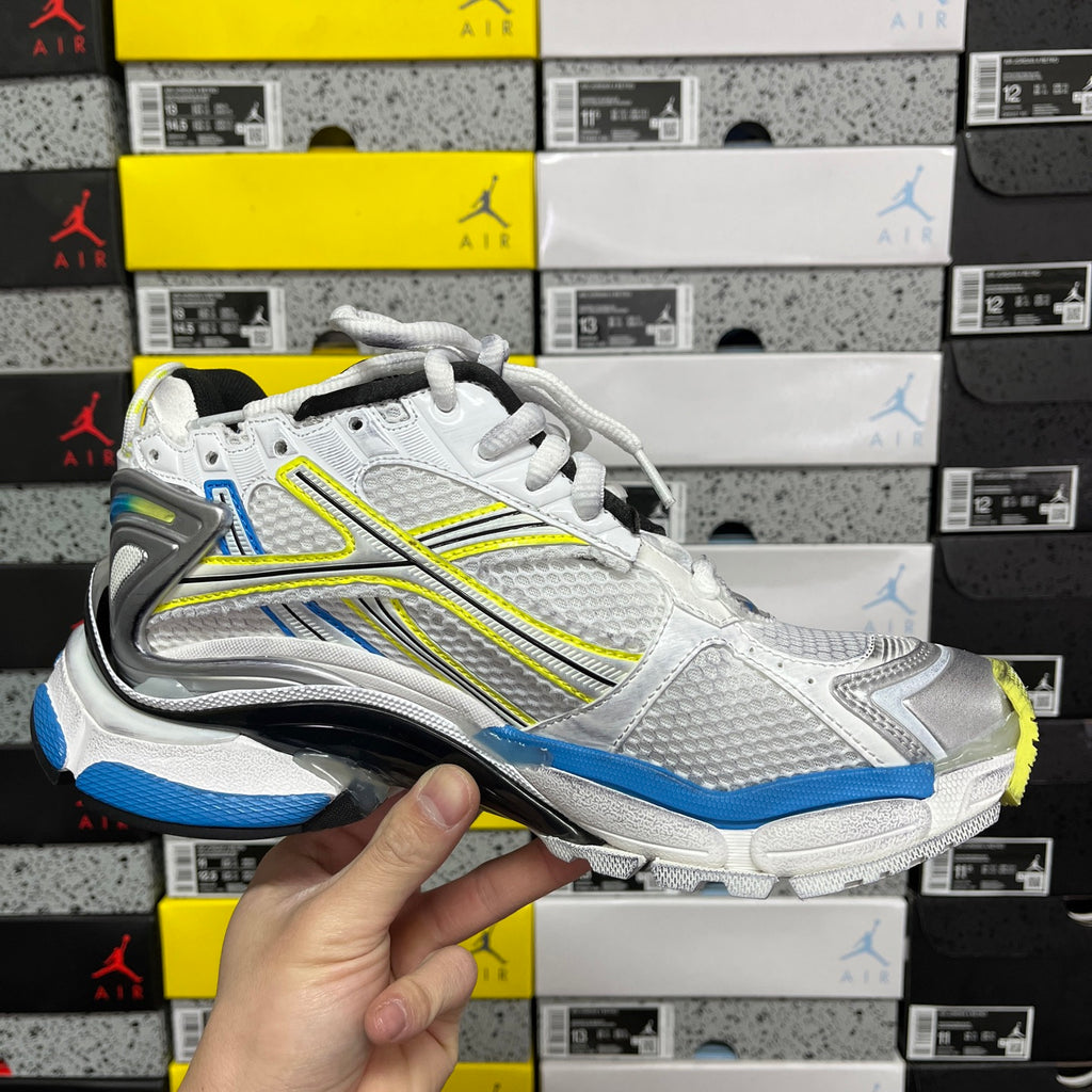 Balenciaga unisex luxury shoes, front view of white lace-up sneaker with blue trim and neon yellow