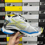 Balenciaga unisex luxury shoes, front view of white lace-up sneaker with blue trim and neon yellow