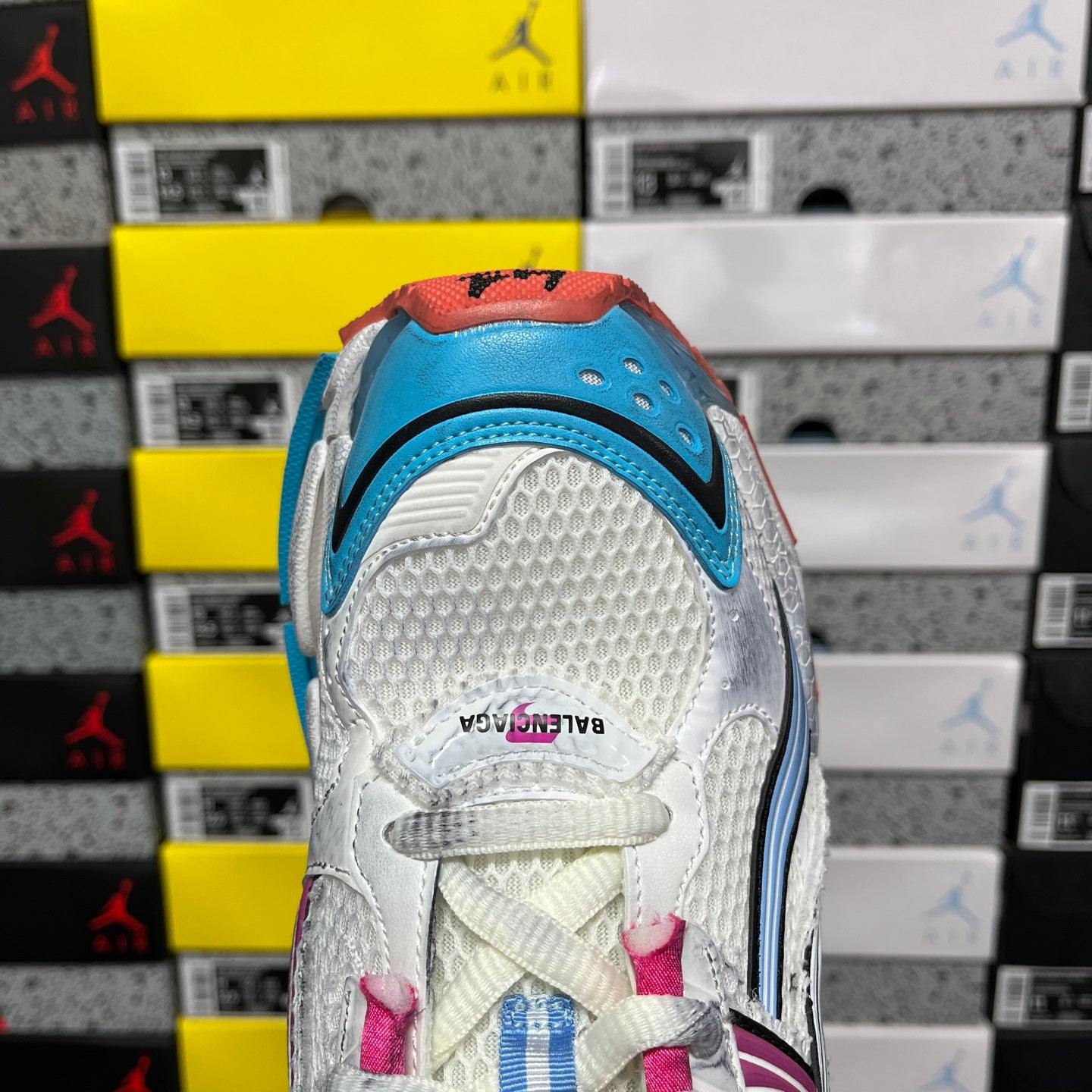 White Balenciaga runner sneaker heel panel with blue insert and pink laces