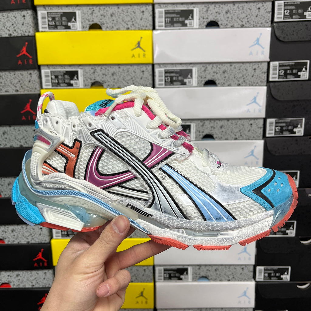 White Balenciaga runner sneaker with blue and pink accents, chunky rubber sole