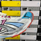 White Balenciaga runner sneaker side profile with blue panel and orange heel