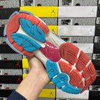 White Balenciaga runner sneaker front view with blue side panel and red sole edge