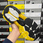 Black and yellow outsole of Balenciaga unisex sneaker with tread pattern
