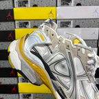 White and metallic Balenciaga unisex sneaker with yellow trim and thick outsole