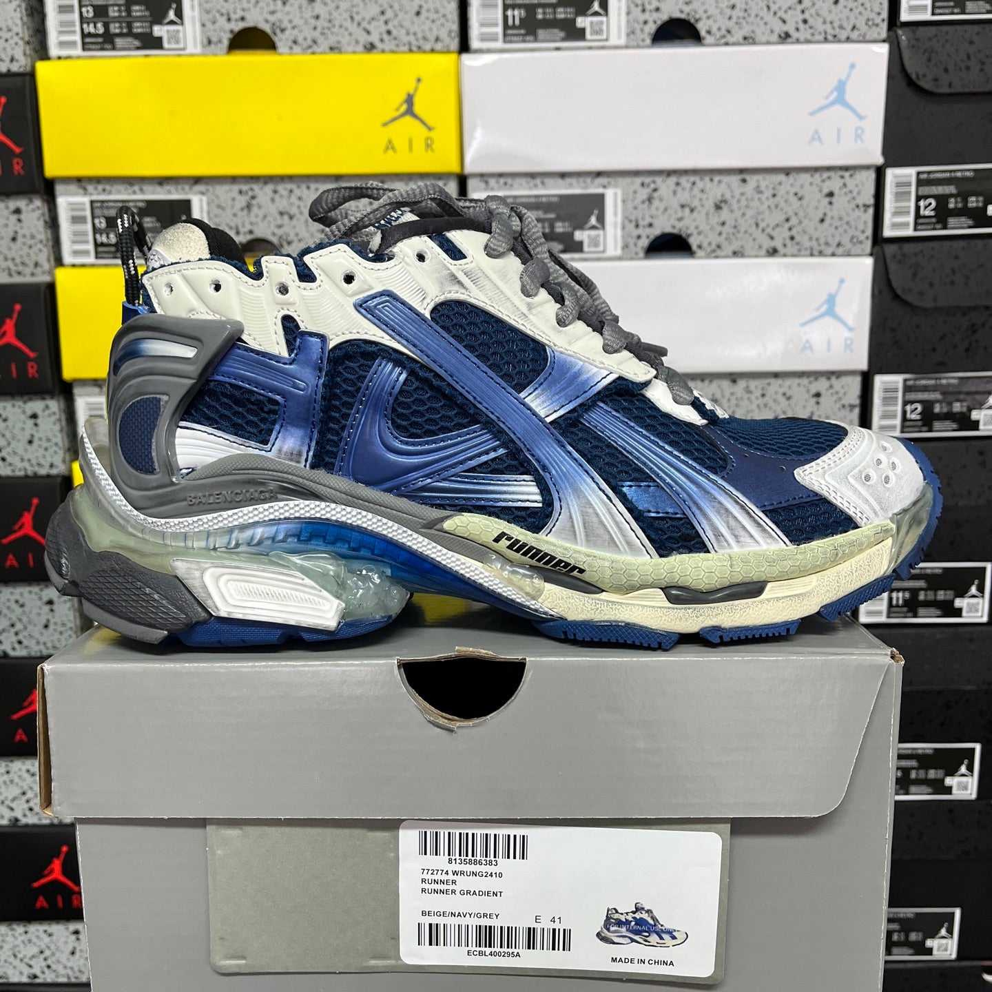 Blue and white running sneaker with clear air sole and gray lace-up closure
