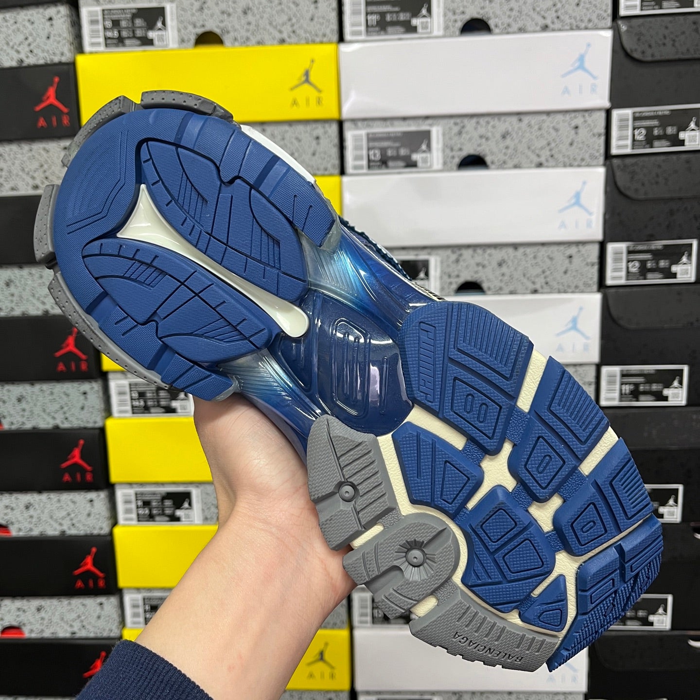 Blue sneaker outsole with textured tread and gray rubber areas