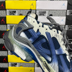 Blue and white running sneaker heel with gray lace-up strap detail