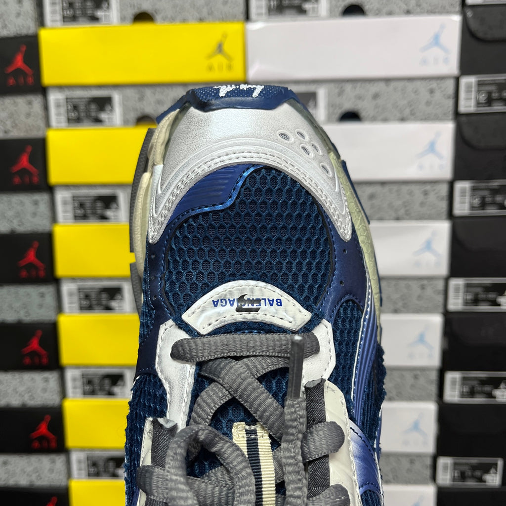 Blue and white sneaker toe with gray laces and mesh quarter panel