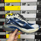 Blue and white running sneaker angled side view with gray laces