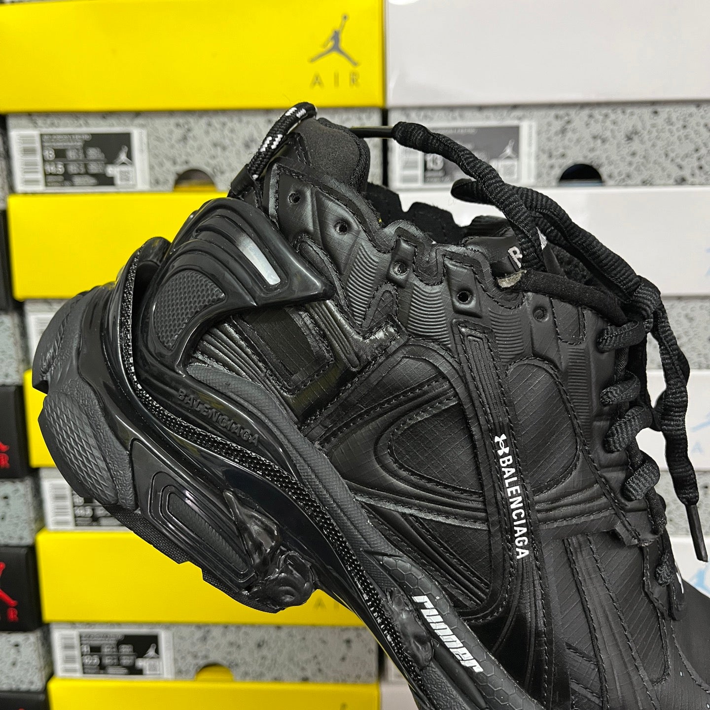 Balenciaga unisex black runner shoe side close-up with lace eyelets