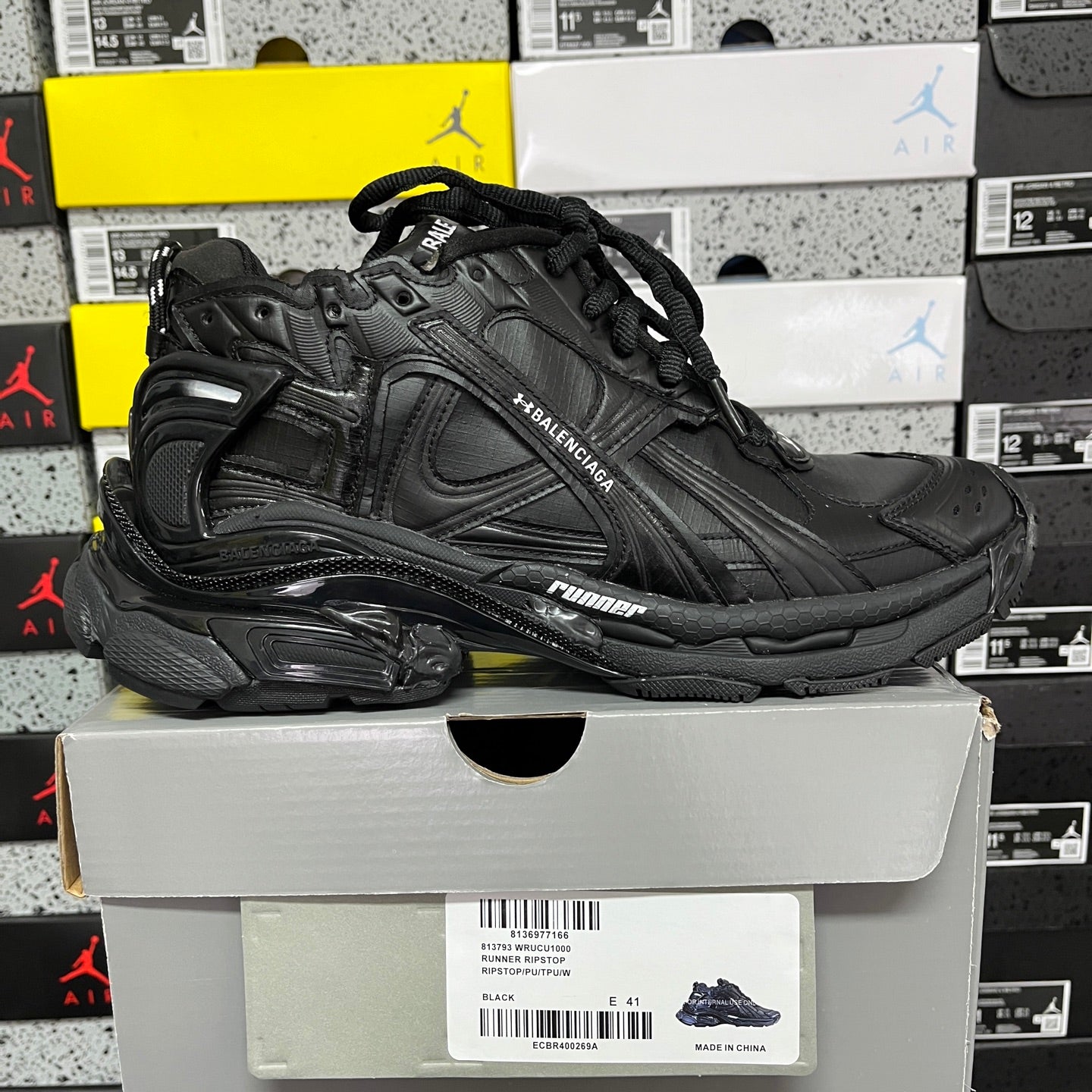 Balenciaga unisex black runner shoe side profile with textured overlays
