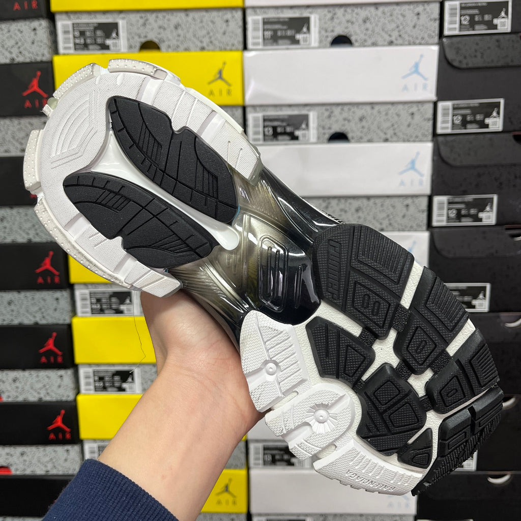 Balenciaga unisex sneaker outsole view, black tread and white midsole with raised ridges