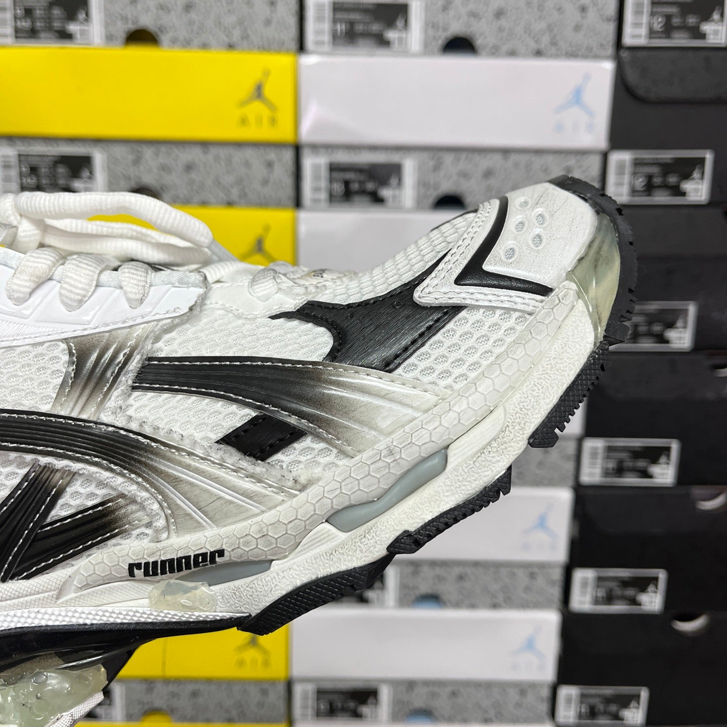 Balenciaga unisex sneaker side profile, white and black upper with silver reflective details