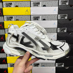 Balenciaga unisex sneaker with white mesh upper and black metallic stripe, lace-up