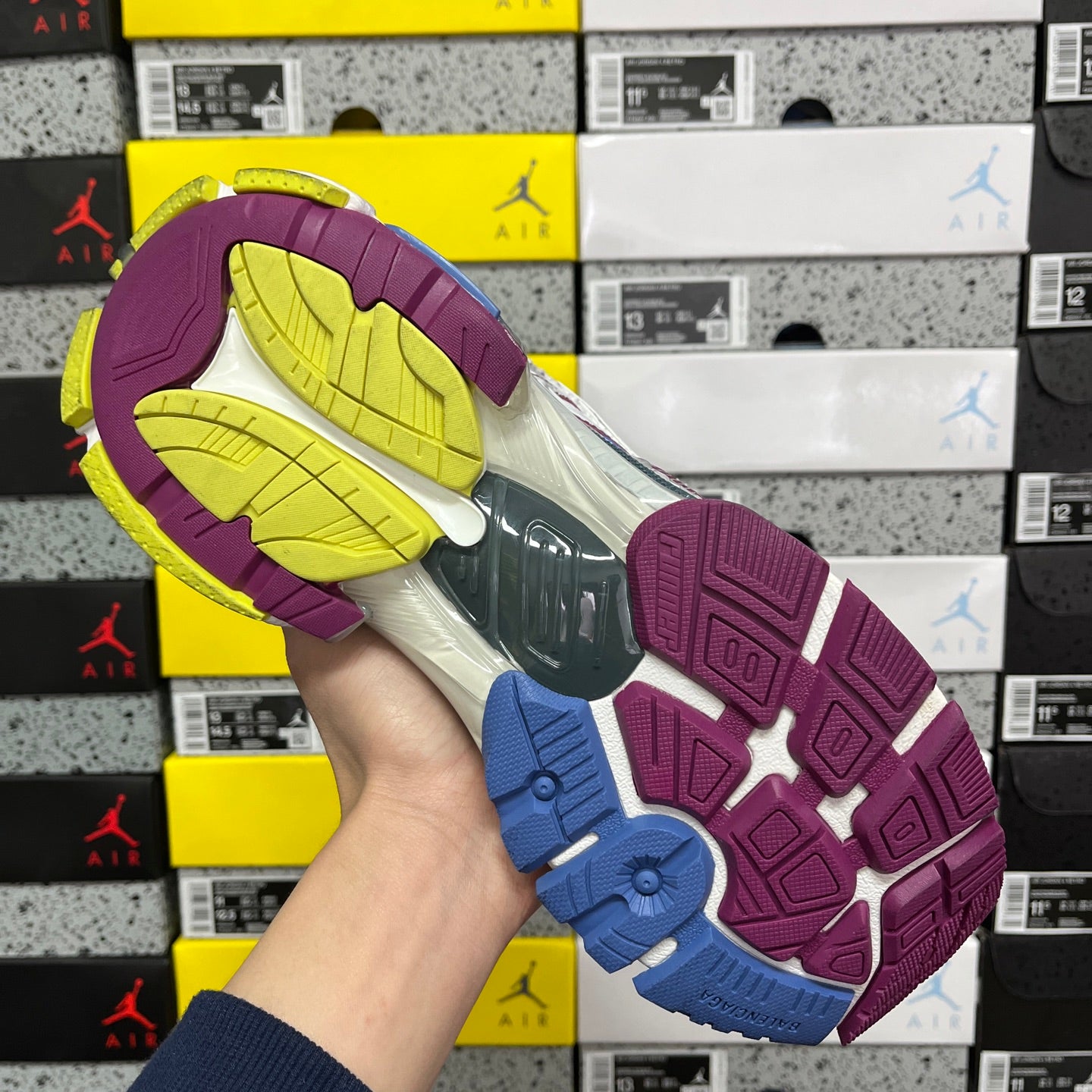 Balenciaga unisex running shoe outsole view, purple tread with blue accents and yellow interior