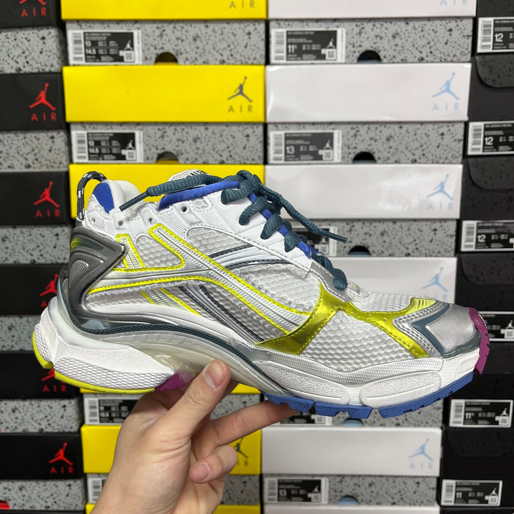 Balenciaga unisex running shoe side profile, white upper with blue laces and neon yellow stripe