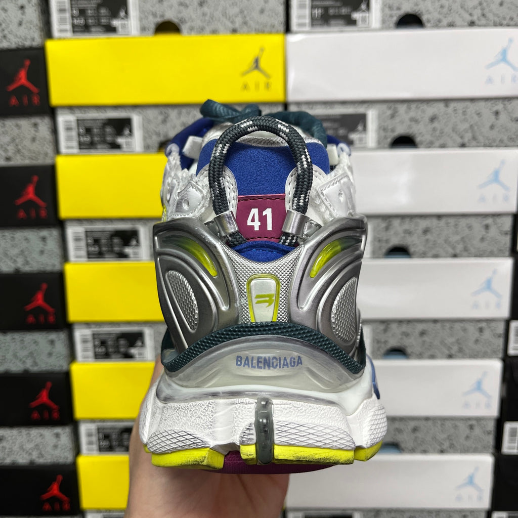 Balenciaga unisex running shoe back view, silver heel with neon green accents and blue collar