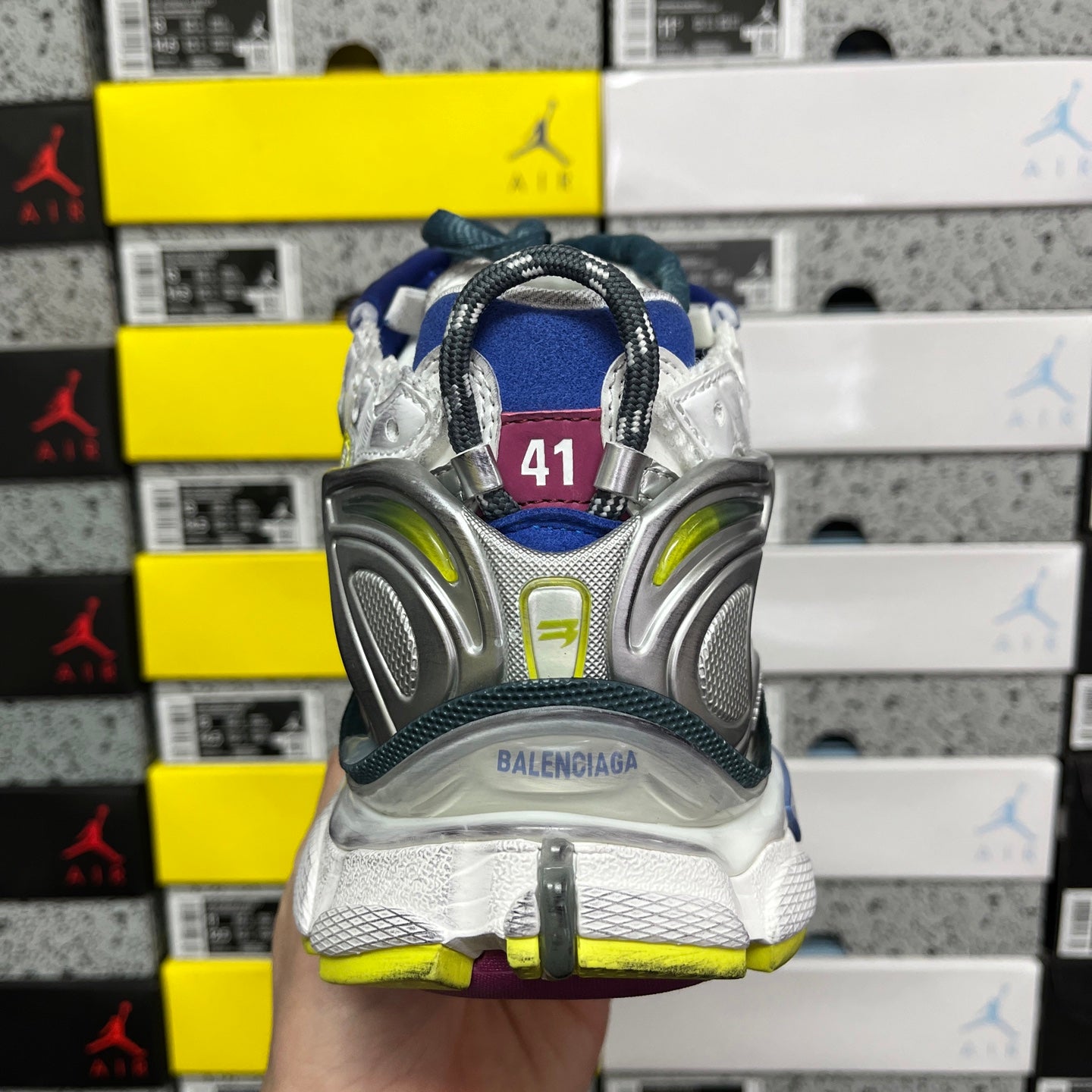 Balenciaga unisex running shoe back view, silver heel with neon green accents and blue collar
