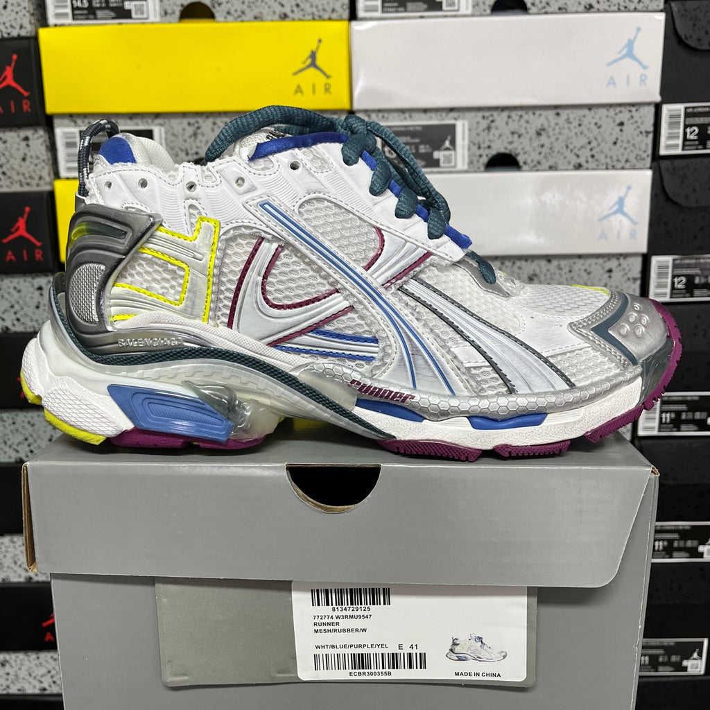 Balenciaga unisex running shoe on box, white upper with blue laces, silver panels, neon trim