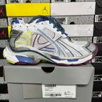 Balenciaga unisex running shoe on box, white upper with blue laces, silver panels, neon trim