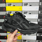 Balenciaga unisex black sneaker with mesh panels, laces, and chunky rubber sole