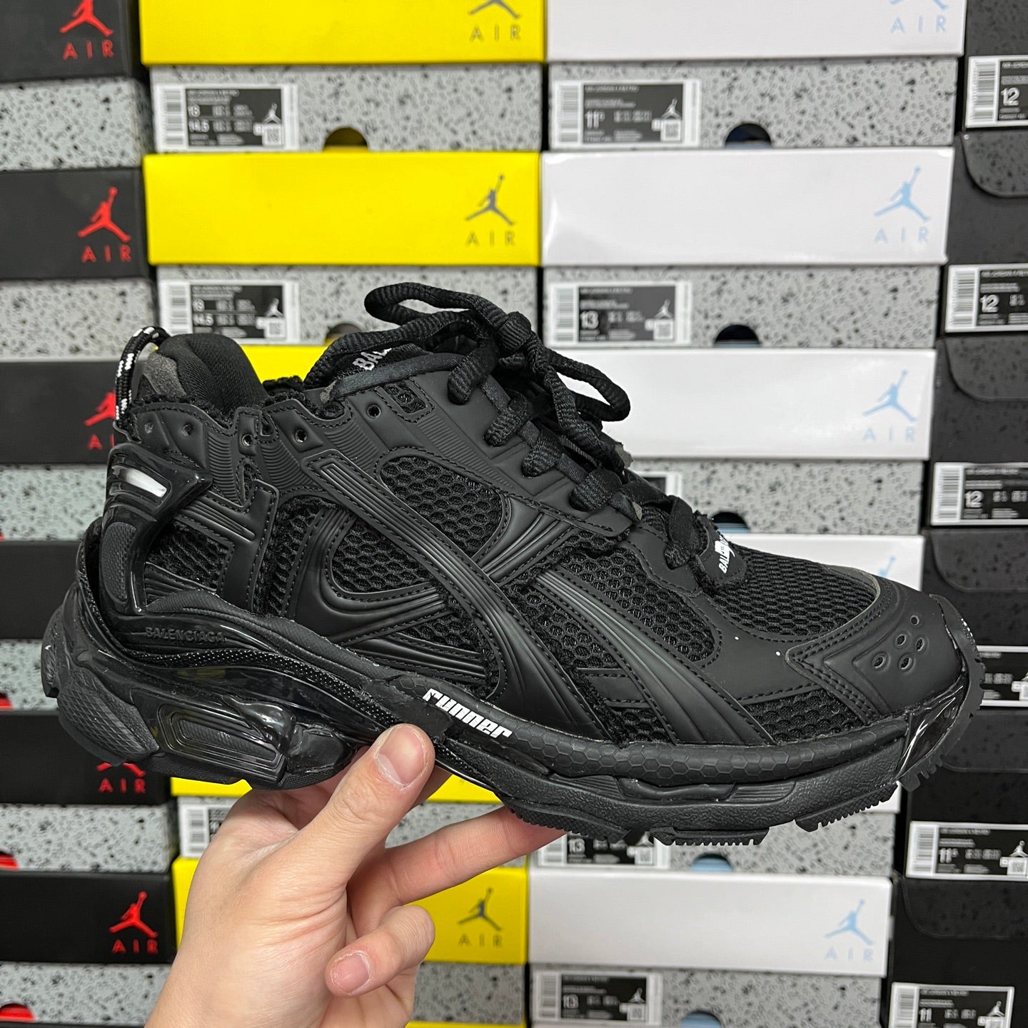Balenciaga unisex black sneaker with mesh panels, laces, and chunky rubber sole