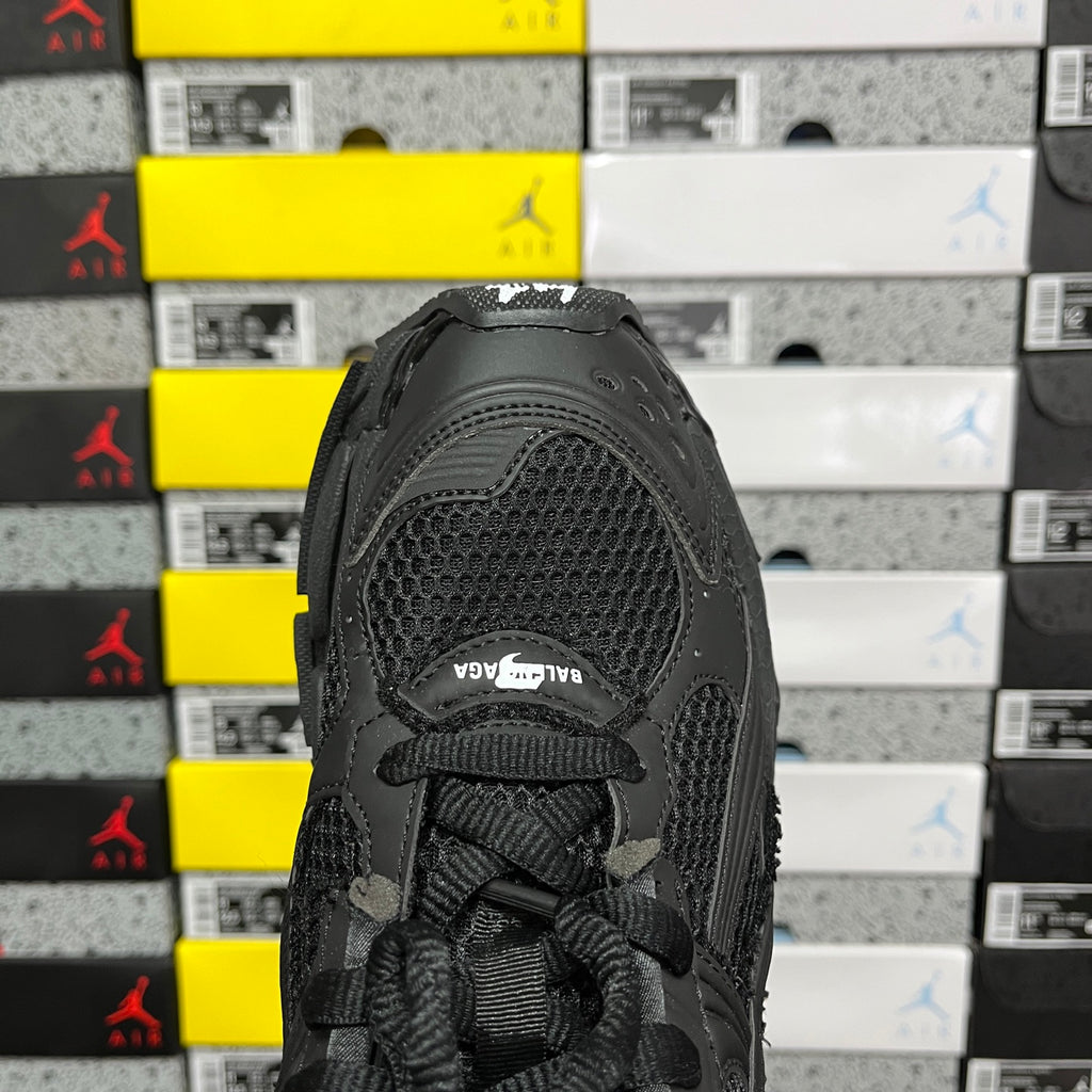 Balenciaga unisex black sneaker heel view, mesh upper and lace-up closure
