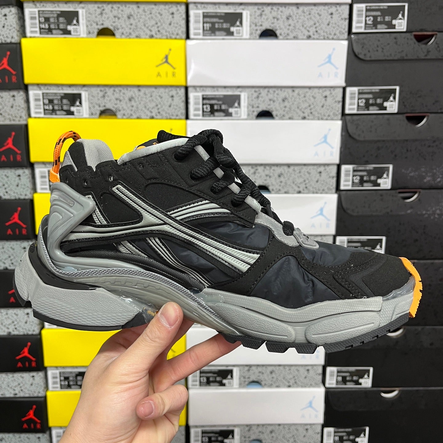Balenciaga unisex sneaker, black upper with gray stripes and orange-outlined sole