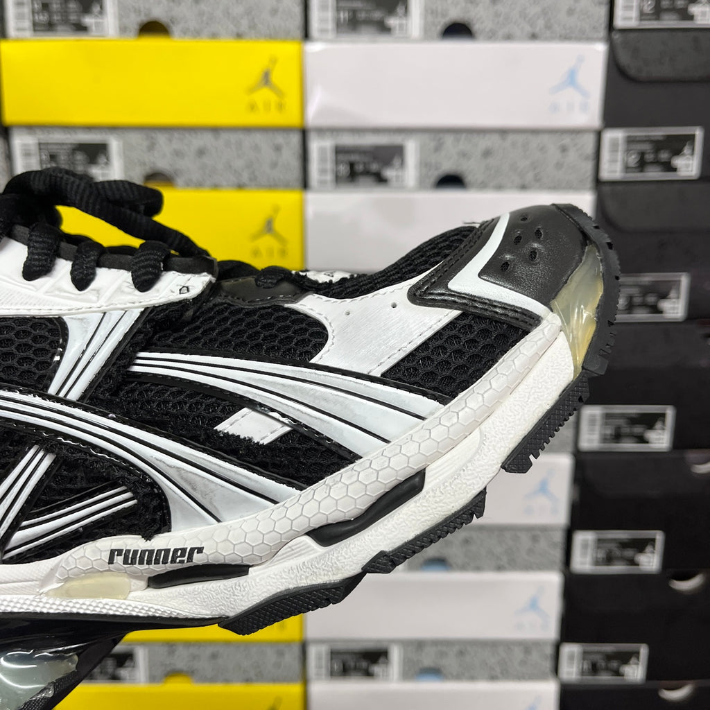 Runner sneaker, black and white side view with textured panels and laces