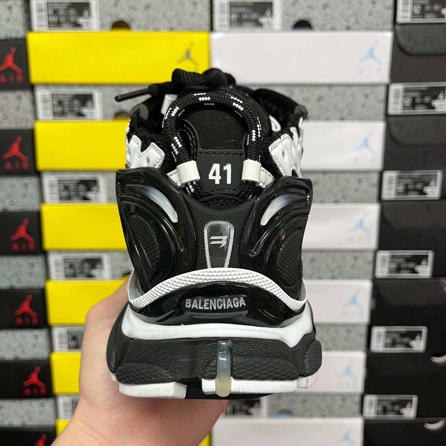 Runner sneaker back view, black heel with size patch and laces