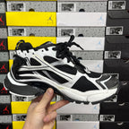 Runner sneaker front side view, black and white with lace-up and layered sole