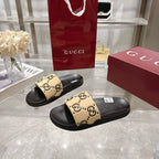 Gucci sandals: black slides with beige GG logo front straps and textured sole
