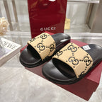 Black slide sandals with beige GG monogram straps and cushioned footbed