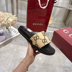 Black slide sandal with beige GG logo strap, side profile with ridged sole