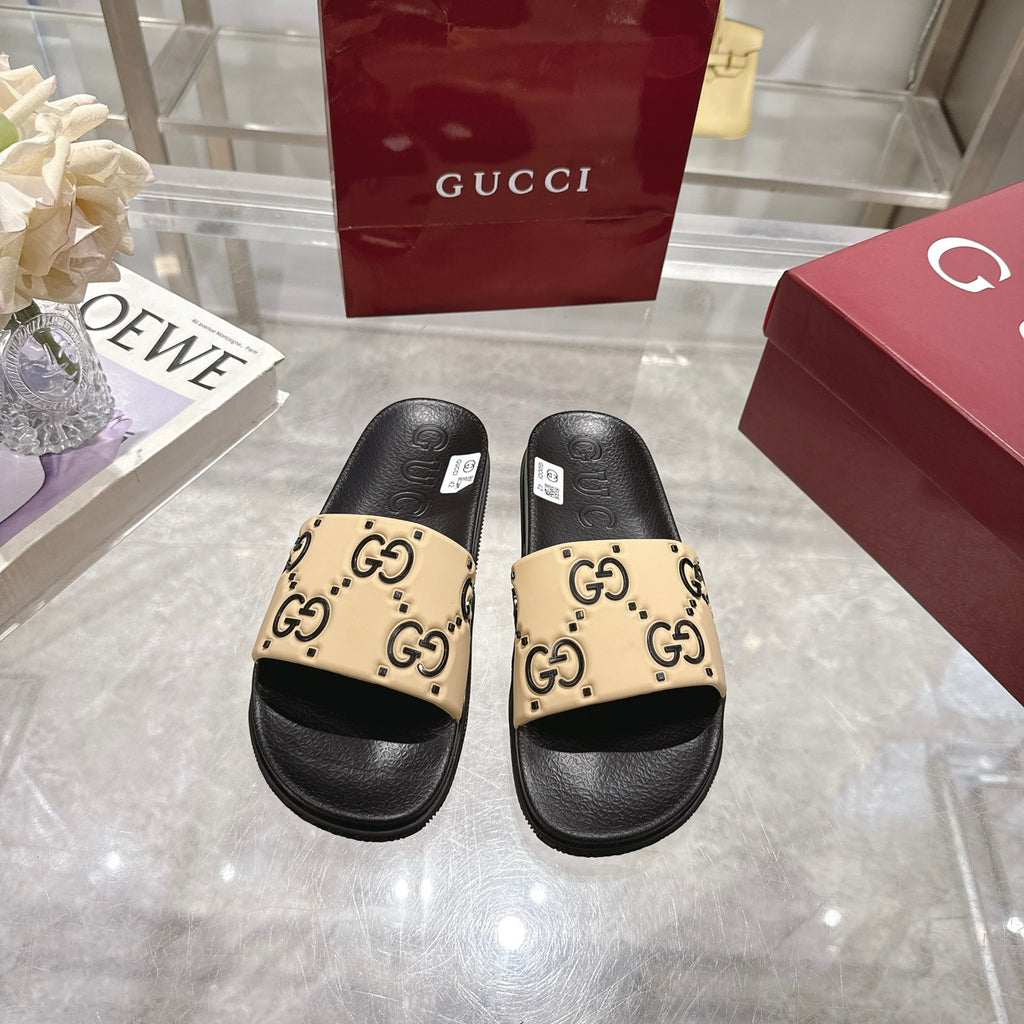 Pair of Gucci slide sandals, black sole with beige GG logo patterned straps