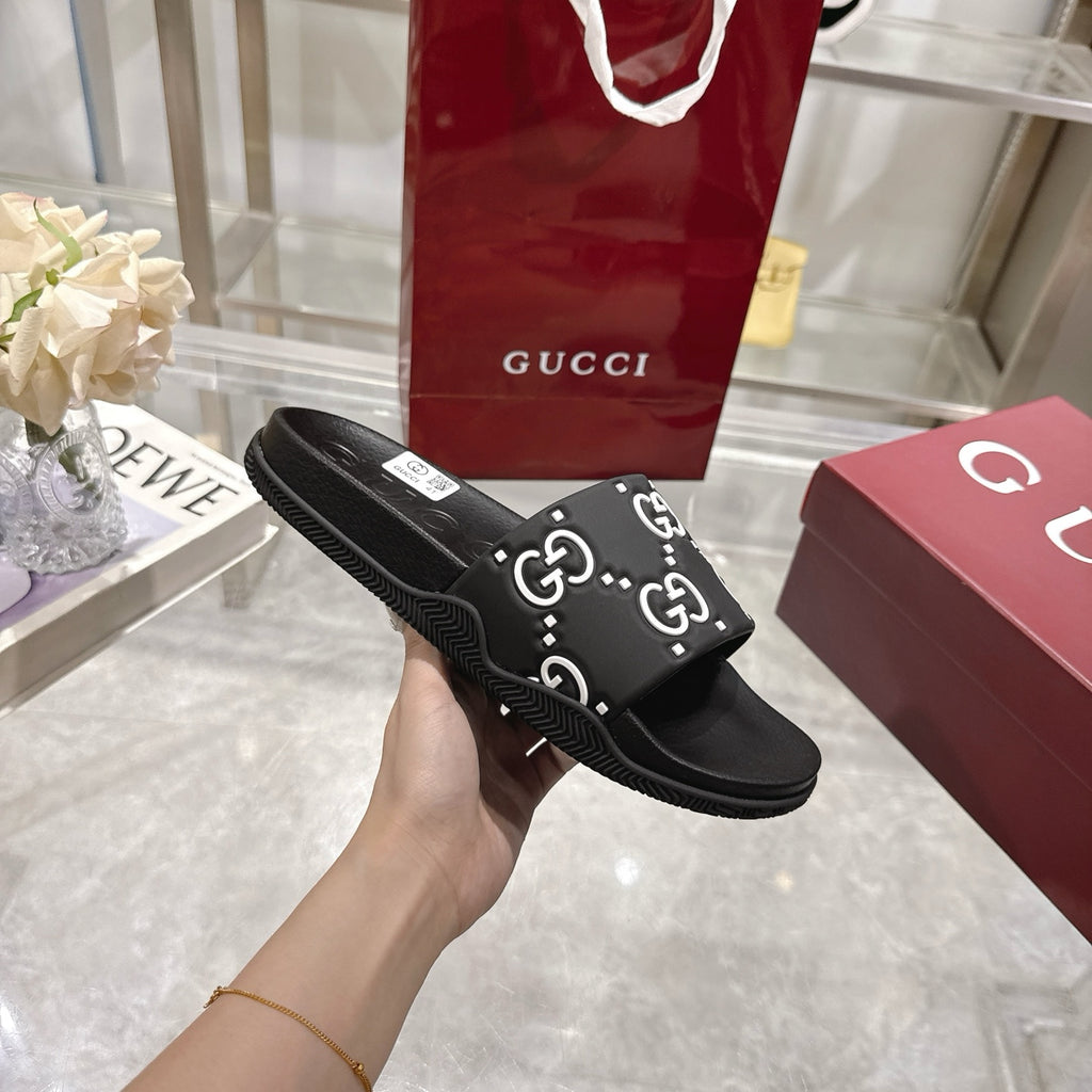 Gucci black slide sandals with GG monogram strap and slip-on slide design