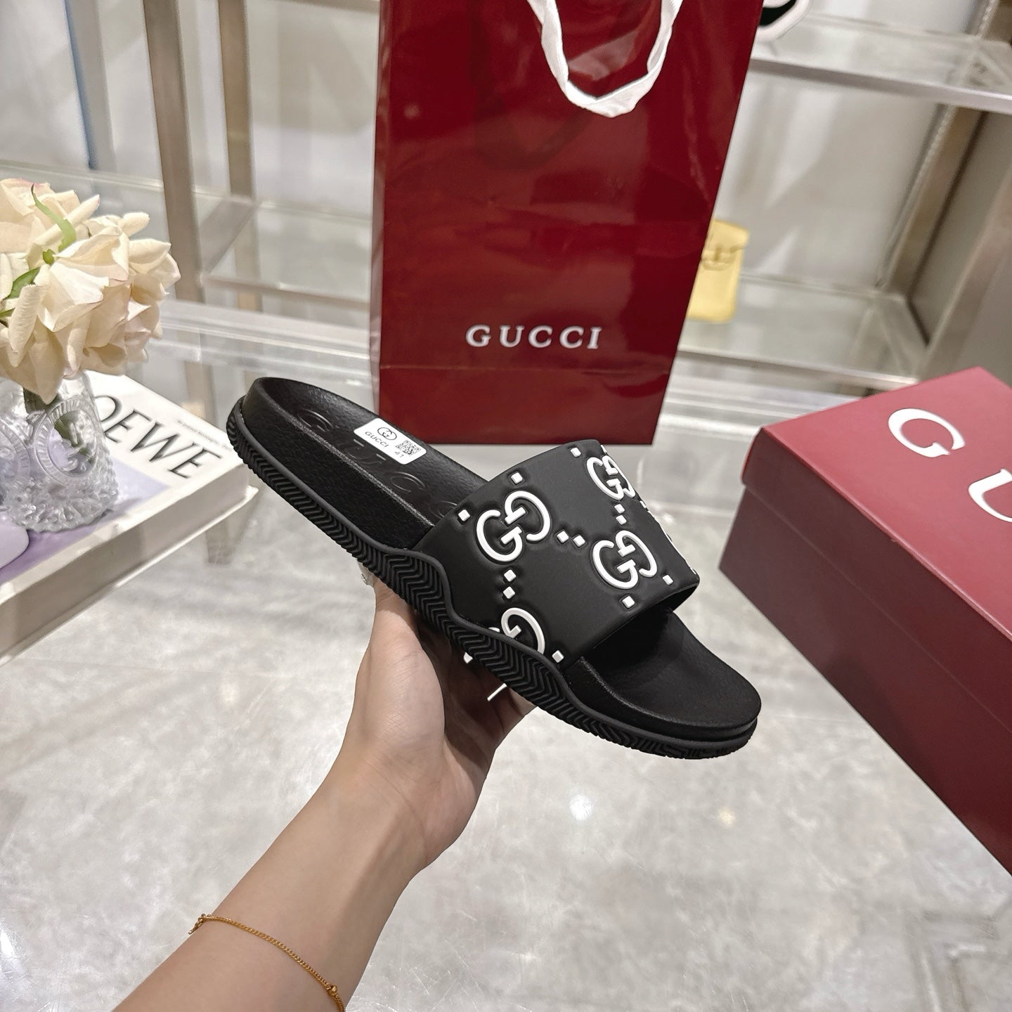 Gucci black slide sandals with GG monogram strap and slip-on slide design
