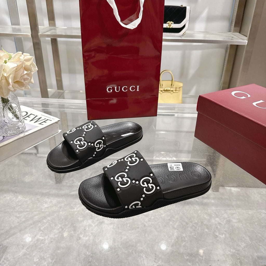 Gucci black slide sandals with GG monogram strap and cushioned footbed