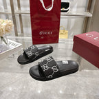 Gucci black slide sandals with GG monogram strap and cushioned footbed