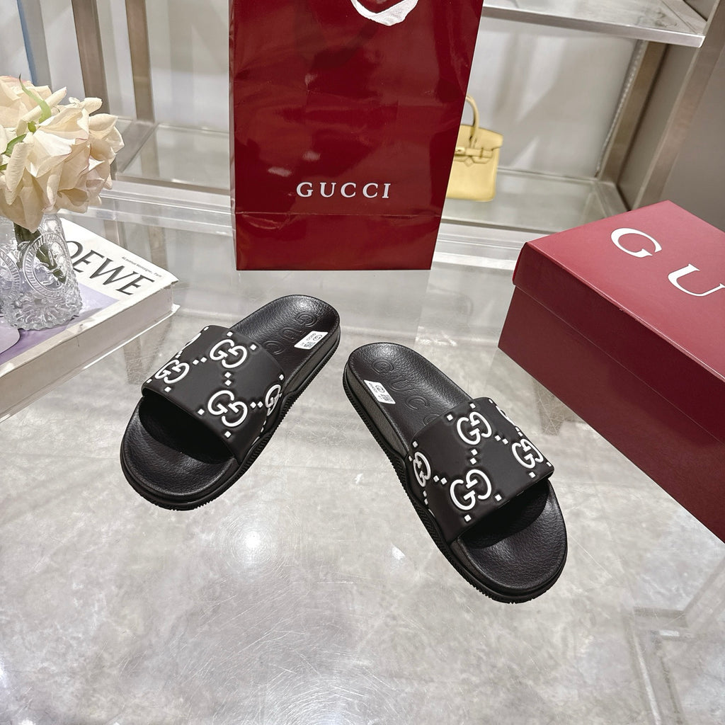 Gucci black slide sandals, GG logo print strap, contoured black rubber sole